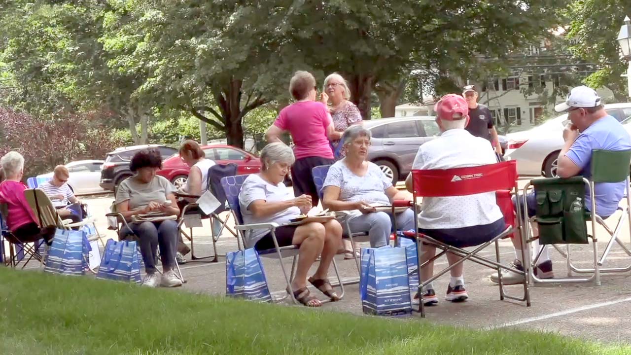 An image of seniors at an outdoor lunch.